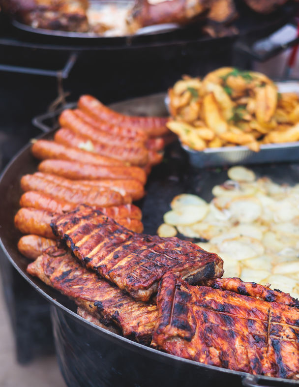 Catered BBQ food on grill at a Detroit event